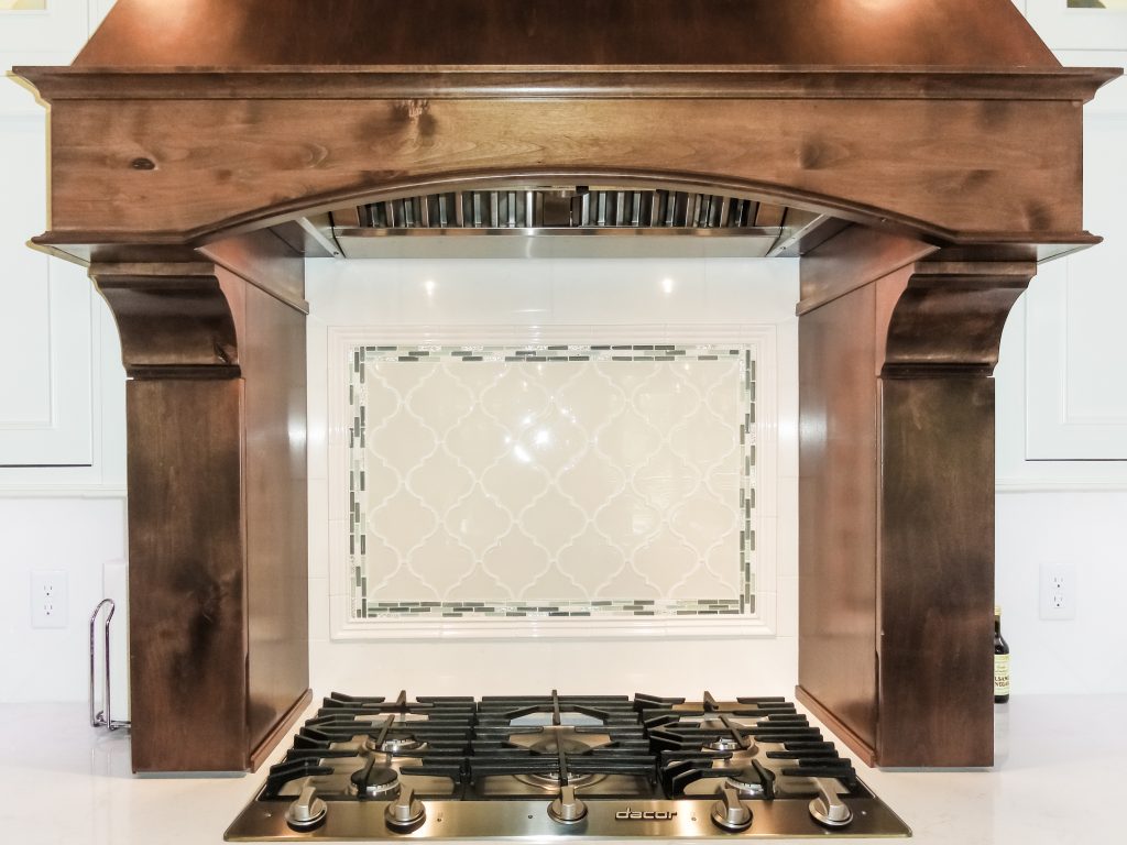 oven range backsplash, backsplash, wood stove hood vent, white cabinets