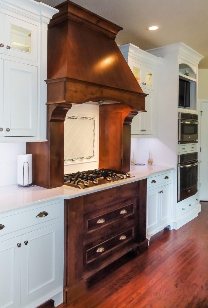 stained oven hood, stained stove, white cabinets, wood floors, rustic kitchen, farmhouse kitchen